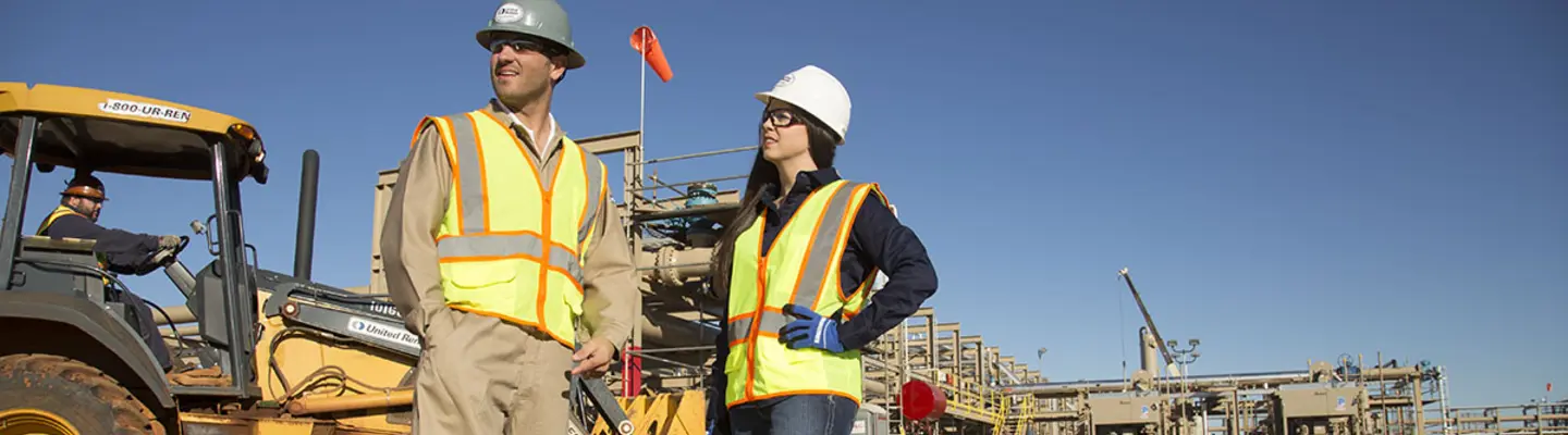 man and woman on construction site in PPE 