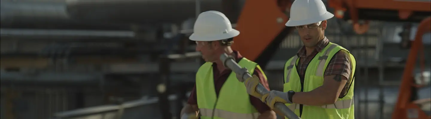 two men in hard hats on construction site