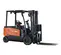Side view of an orange and black Doosan warehouse forklift with a black mast, black forks and an open cabin.