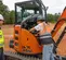 Orange, gray and black HITACHI 7,000-10,000 lb. Mini Excavator, Zero Tail Swing