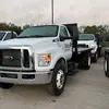 Angled front-right view of a white pickup truck with a black flatbed.
